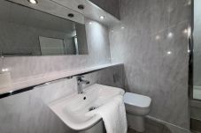 beautifully designed bathroom with sink, toilet and tiled floors