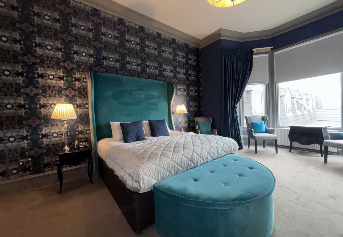 Elegant king bed in the Full Suite at Richmond Park Hotel, providing a comfortable stay for guests.