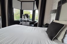 Spacious Junior Suite at Richmond Park Hotel Bo'ness, showcasing dual aspect views of the mountain range.